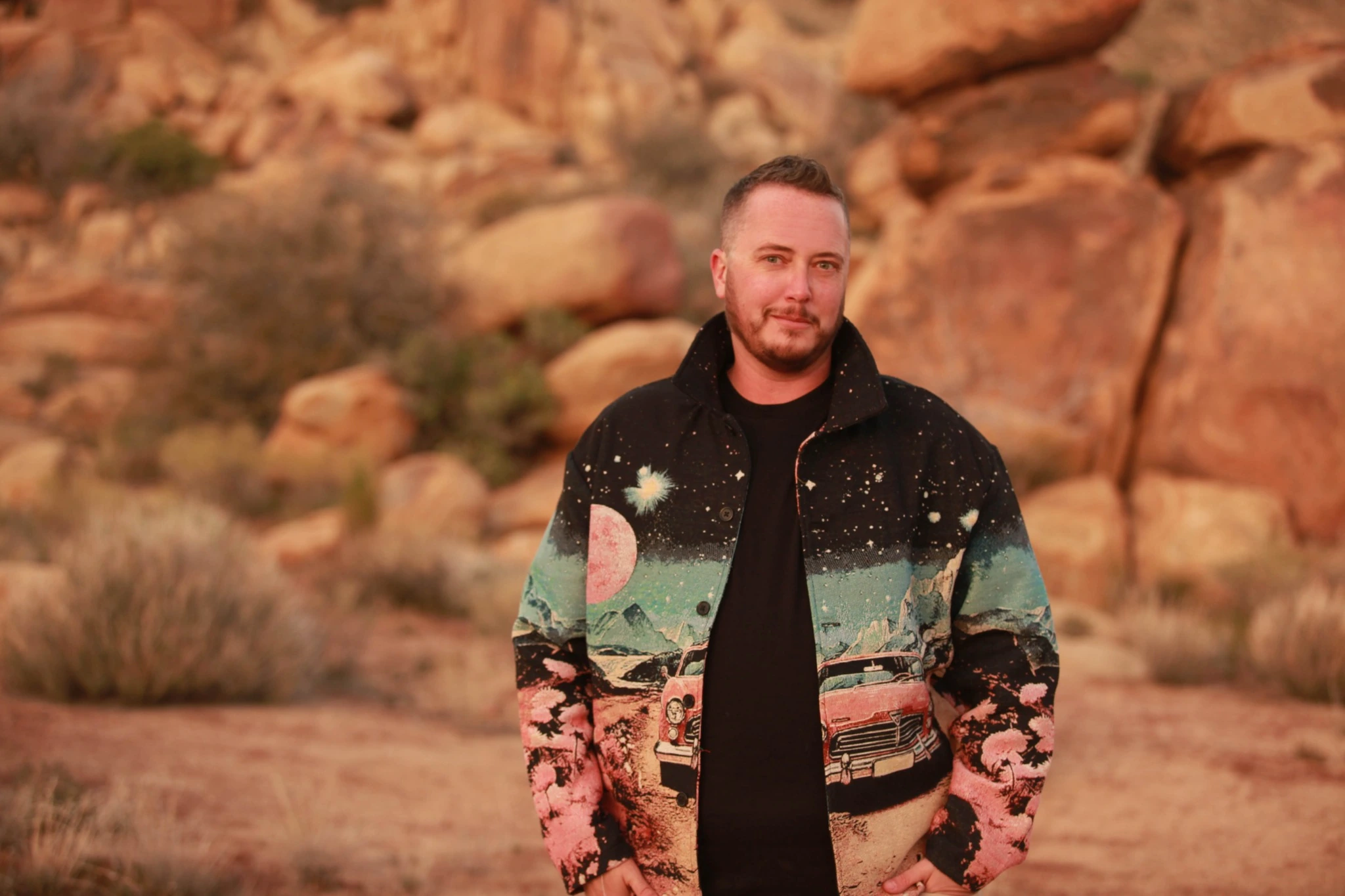 Ayce Kyptyn outdoors in a patterned jacket